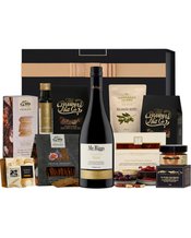 The Hamper Emporium Red Wine<br>& Nibbles Hamper 750mL This delicious gourmet hamper is a bestseller for a reason. It's bursting with goodies from the Mr. Riggs McLaren Vale Shiraz to a range of indulgent savoury nibbles and pantry essentials that are all of the highest quality. Give this gourmet food and wine hamper as a gift—your recipient will be able to entertain guests or enjoy their spread solo. It's presented in a black keepsake box lined with luxury embossed paper, so no further gift wrapping is needed. Due to seasonal variations and exclusi
