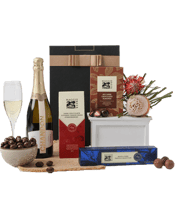  The Hamper Emporium<br>Chocolate Bliss... 750ML Chandon toasts are a moment of pure joy when shared with friends, especially when the toast includes a gourmet chocolate hamper like this one. The bottle of Chandon Sparkling Chardonnay is the main attraction, perfectly complemented by rich Dark Chocolate-coated Strawberries, Maggie Beer's 80% Dark Chocolate Almonds, and a box of Chocolate Truffles. Bliss with every bite.<br>Due to popular demand and seasonal variation, hamper contents may vary. Enjoy food before the use-by date.