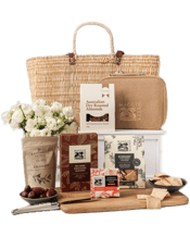  The Hamper Emporium Large<br>French Market... 750ML Treat your gift recipient to a gourmet lunch with this gorgeous basket of goodies. Handmade in Morocco by artisans using water reeds, Maggie Beer's large market baskets are sturdy, stylish, and stunning. They boast two sets of handles for easy carrying and a genuine leather patch featuring Maggie's signature.<br>Open the basket and your gift recipient will discover a selection of savoury nibbles. They can create a delicious cheese spread with a Teak Wood Cheese Board, enjoy fruit paste on rosema