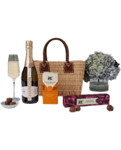  The Hamper Emporium French<br>Market Basket Mini... 750ML Raise a glass in style with this exquisite luxury gift hamper – the perfect way to celebrate life’s special moments. This beautifully curated gift begins with the charming mini tote from Maggie Beer, a stunning French market basket handcrafted in Morocco by skilled artisans using natural water reeds. The genuine leather handles add a touch of elegance and durability, making it both practical and beautiful.<br>Nestled inside is a bottle of Chandon Sparkling Chardonnay, ready to be popped open for
