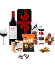 Purely Gourmet Penfold &<br>Australian Sweets... 700mL For all those premium red wine lovers, Penfold is a brand that can't go wrong. Accompanied by some of Australia's best gourmet sweets, this will keep the recipient absolutely satisfied! Hamper Includes: - Penfold Kalimna Bin 28 Shiraz 2018 750ml - Get Farmed Chickpea Puffs 80g - Bramble & Hedge Nougat 150g - Whisk & Pin Rocky Road 150g - Whisk & Pin Fruit Salad 50g - Random Harvest Traditional Raspberry Drops 170g. Comes in well presented black magnetic box with a red bow. Please note: In the