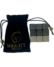  Solkatt Designs Hand Cut<br>Granite Whisky Stone...  Crafted from natural granite, these reusable stones keep your drink chilled without diluting it, preserving the full flavour.<br>Natural Granite: Retains your drink's temperature while maintaining its original taste.<br>Hand-Cut Precision: Ensures optimal cooling and a perfect fit in your glass.<br>Reusable: Eco-friendly alternative to ice that won’t dilute your drink.<br>Elegant Colours: Comes in a set of nine stones in three stunning colours.<br>Custom Velvet Bag: For stylish storage and easy