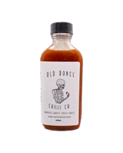  Old Bones Chilli Co Smoked<br>Garlic Chilli... 100ML Made with Australian grown Habanero and Cayenne, using our house crafted smoking method, our Smoked Garlic Chilli sauce is perfectly balanced with a meaty garlic punch, bringing you a full flavoured sauce with a mild palatable burn.<br><br /><br /><br />Whether you need a one stop answer for perfect guac or a zingy garlic twist to your seafood pasta, make this your "secret" ingredient in all your recipes.